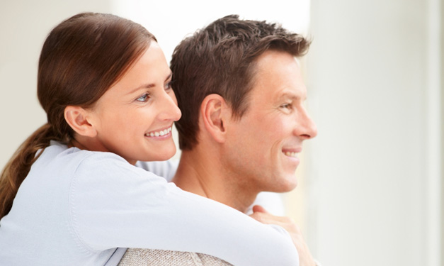 Woman hugs man from behind