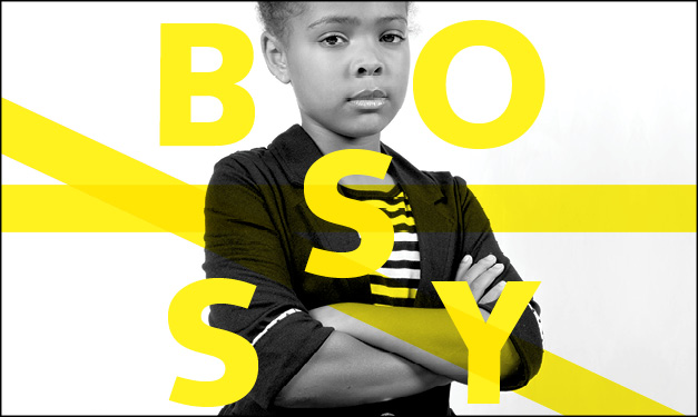 Girl standing with arms folded. The word 'bossy' surrounds her in yellow