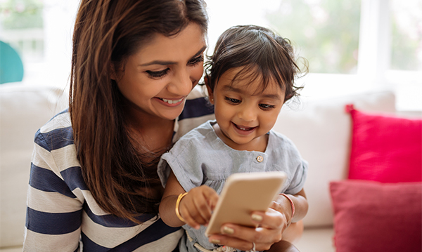A mom and her child playing with a smartphone