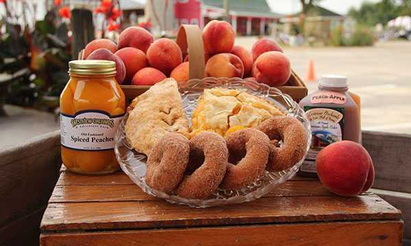 Peach pie, jelly and peaches on a wooden table