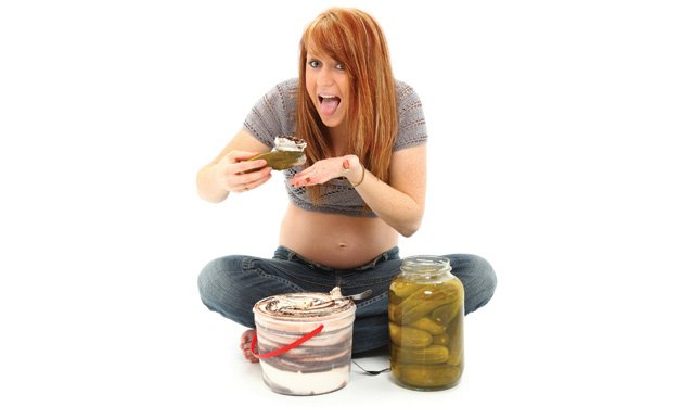 Woman sitting on ground eating pickles and ice cream