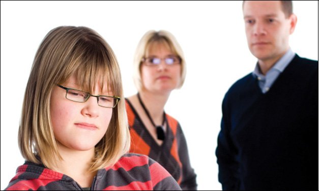 Sassy child standing in front of her parents
