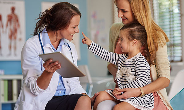 doctor talking to a woman and a child