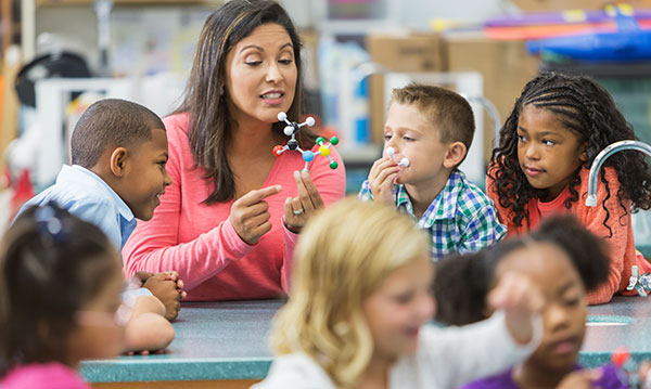 Teacher surrounded by students
