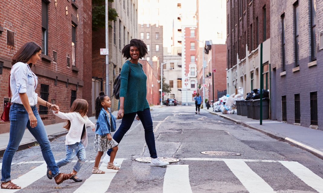 Family of four walking down a city street