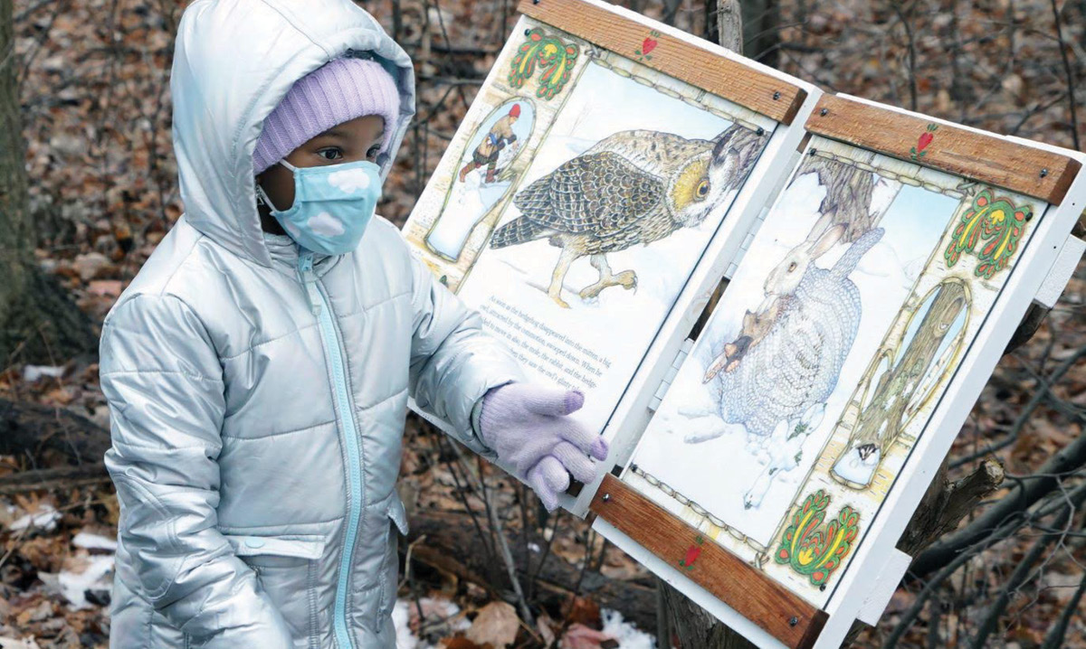Children walking along a storybook trail Family-Friendly Storybook Trails for Kids