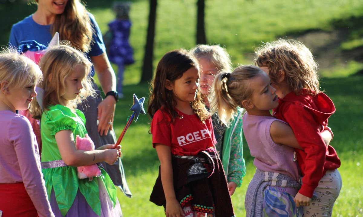 Young students at The Roeper School enjoying outdoor play and creative dress-up activities during early childhood education programming.