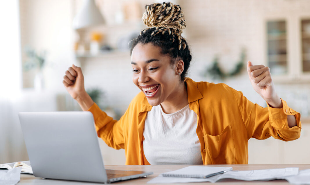 Excited young woman celebrates financial planning success with her MESP College Savings Account during an online session.