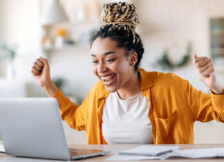 What are the benefits of an MESP college savings account? Excited young woman celebrates financial planning success with her MESP College Savings Account during an online session.