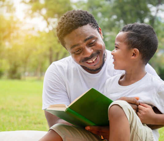 Create a Fun and Engaging Summer Book Club for Kids A group of children gathered around a table discussing books in a summer book club