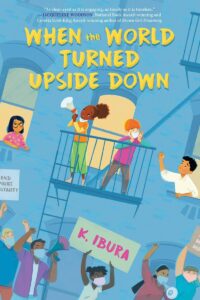 Cover of the book When the World Turned Upside Down by K. Ibura. The illustration depicts a diverse group of children and community members on balconies and in the streets, holding protest signs and megaphones, emphasizing themes of activism, resilience, and social change.