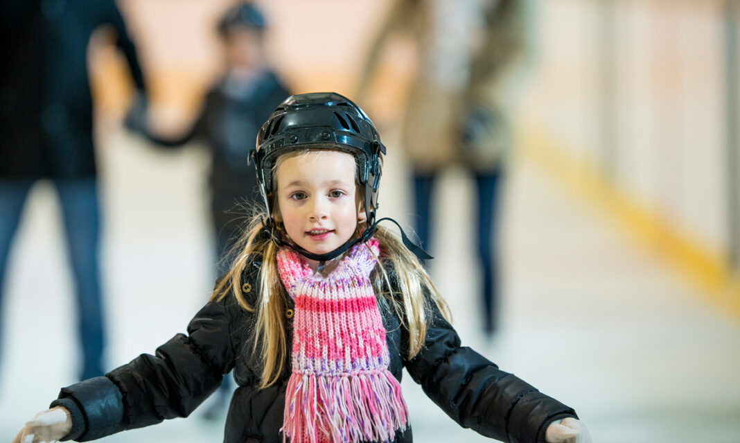 A child participating in ice skating lessons in Macomb County, enjoying a fun and active winter activity.