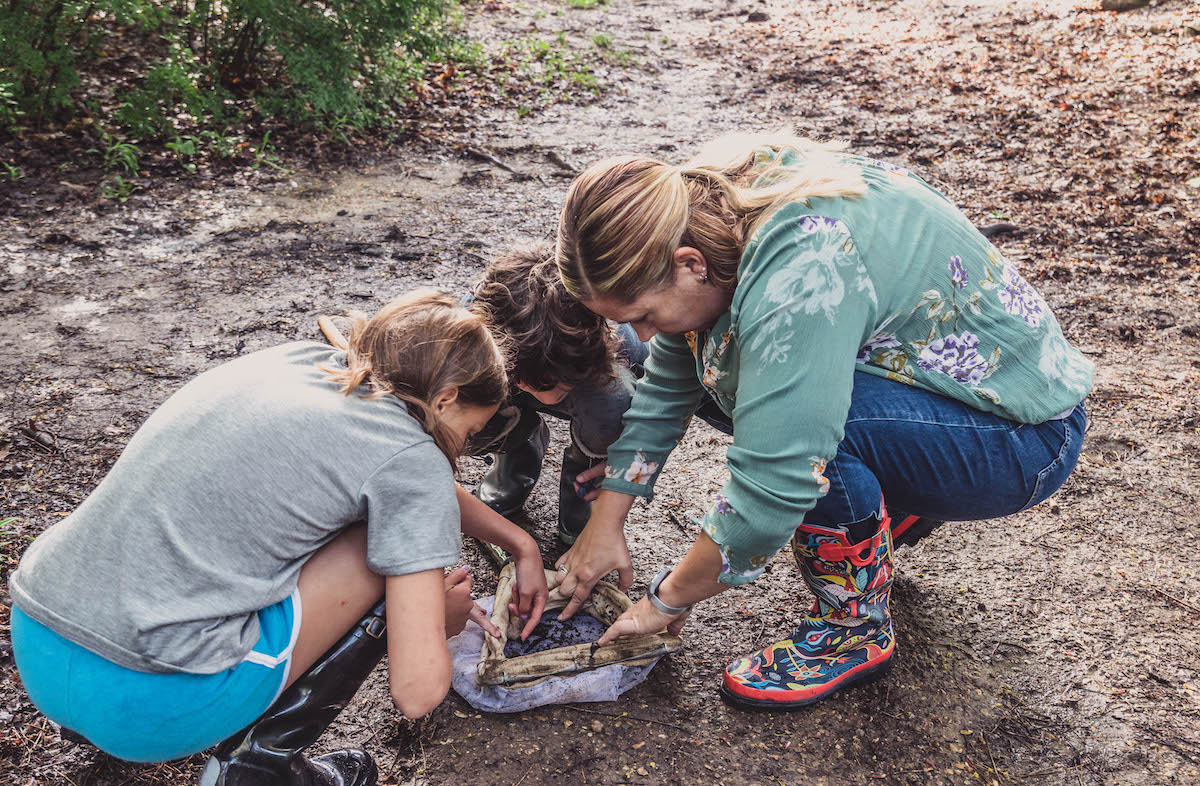 love-of-learning-children-investigating-outside-with-teacher