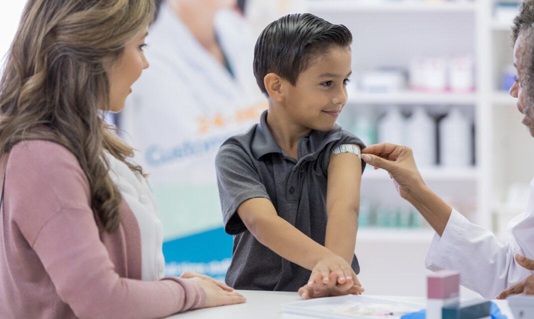 young boy proud of getting his vaccination