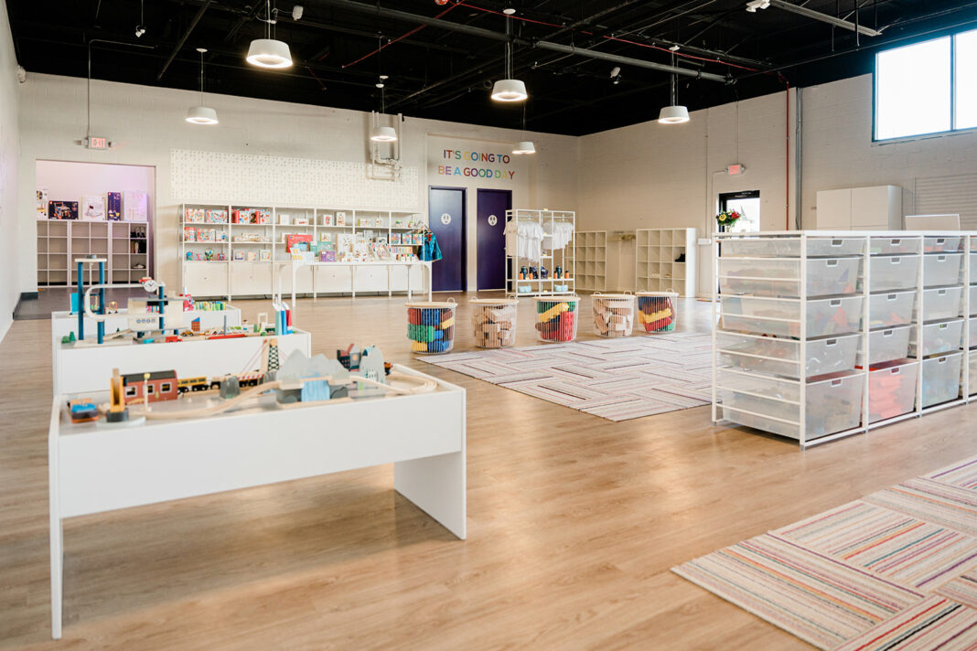 Interior of Fascination Factory in Birmingham, showcasing creative play areas, colorful storage bins and interactive activity tables for kids to explore and enjoy.