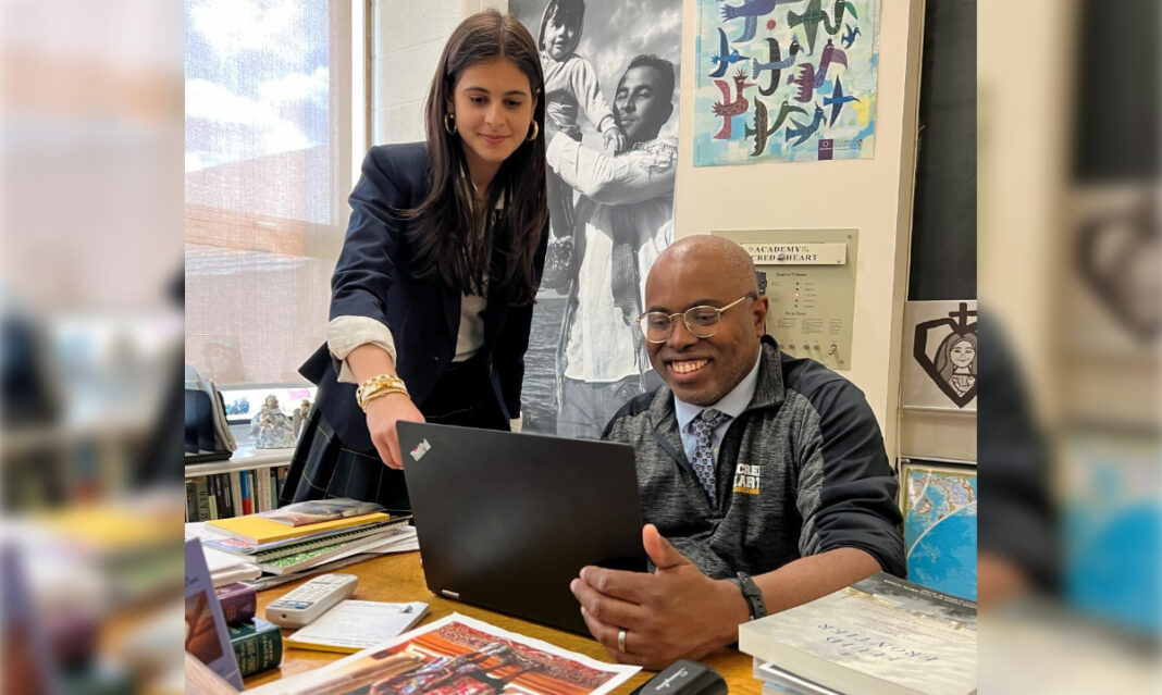Academy of the Sacred Heart student shows a faculty member a new app she developed
