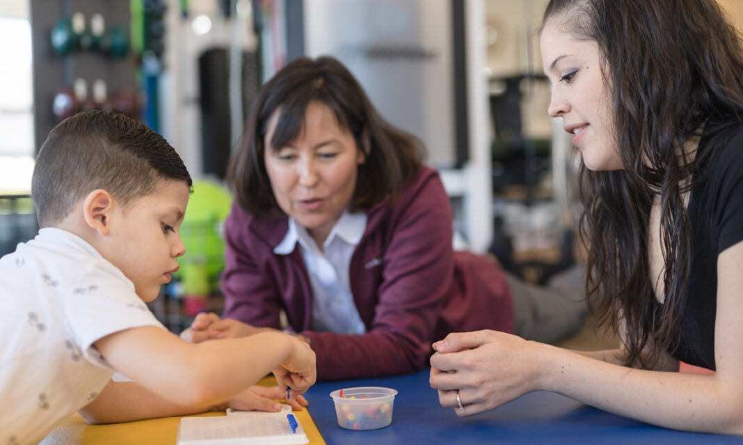 comprehensive-aba-therapy-two-therapists-working-with-one-child-with-autism