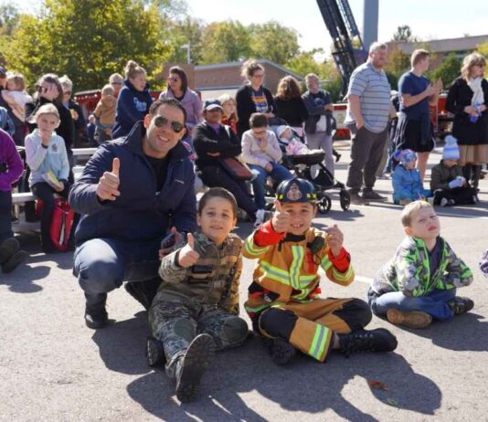 Families and kids in costumes enjoy activities at the Farmington Hills Citywide Open House with fire trucks and demonstrations.