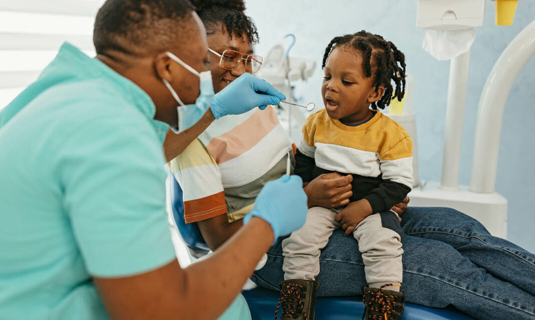 medical-and-dental-visits-for-child-with-autism-small-boy-moms-lap-dentist-chair