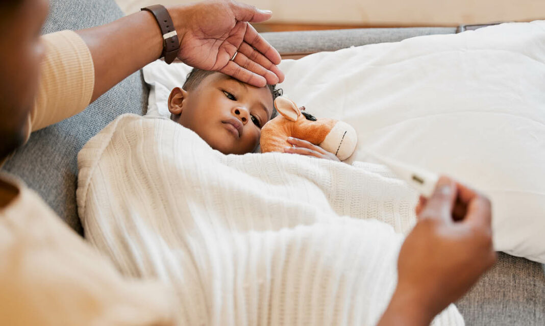 Sick little boy having his temperature taken