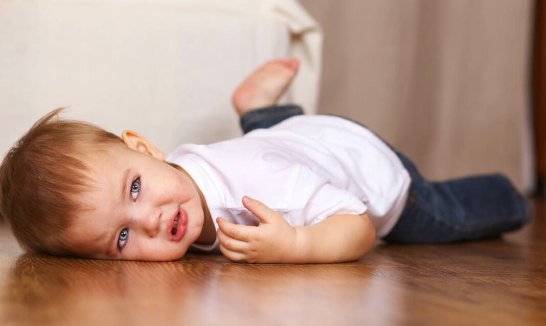 A teary-eyed toddler boy