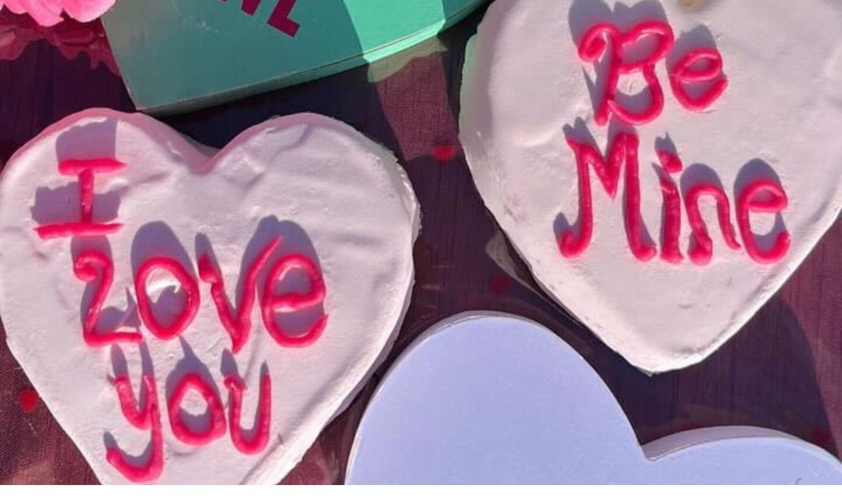 Heart-shaped Valentine’s Day cookies decorated with pink frosting and red lettering reading "I Love You" and "Be Mine." Perfect for celebrating love and friendship with sweet treats.