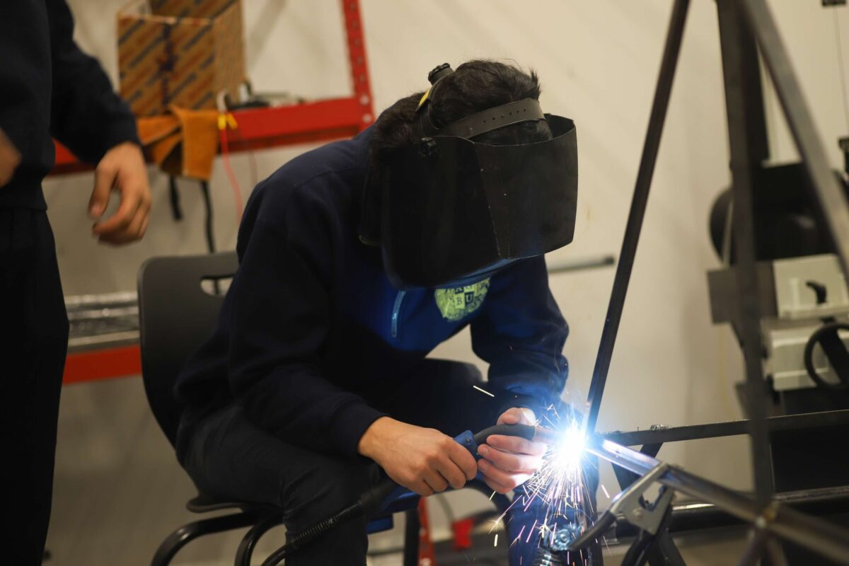 Student welding at STEAM Class in Manoogian School