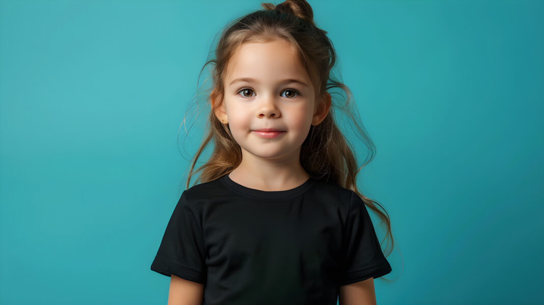 Portrait of a cute and happy young girl wearing a black t-shirt on a cyan background mockup
