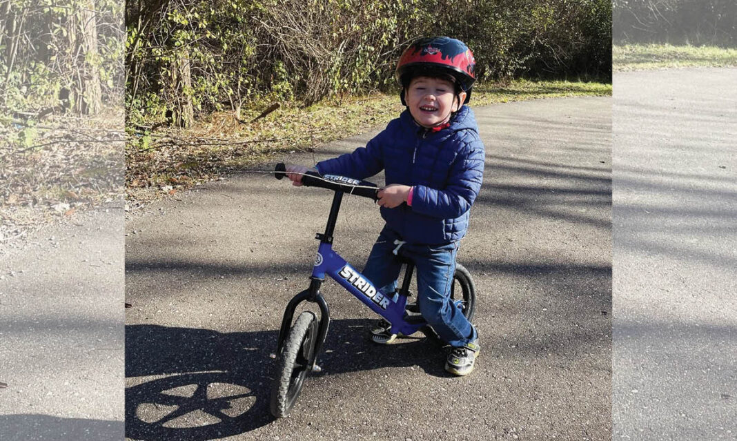 Young Boy from the Leising Family Riding his Bicycle enjoying YMCA Membership Benefits