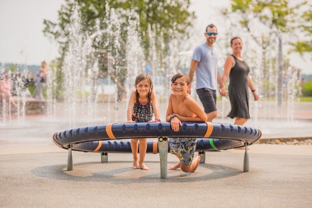 family at splash pad summer activities for kids in traverse city