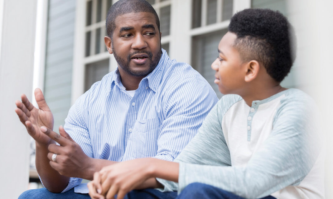 Attentive son listening to his dad advice
