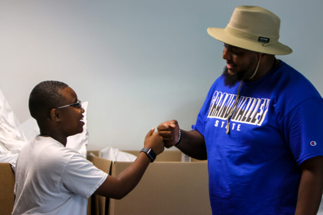 gvsu-college-prep-week-student-advisor-bumping-fists