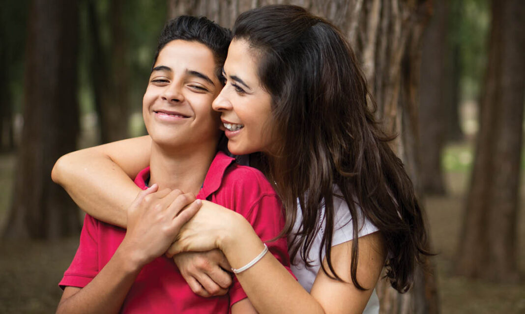 Mother and son hugging each other