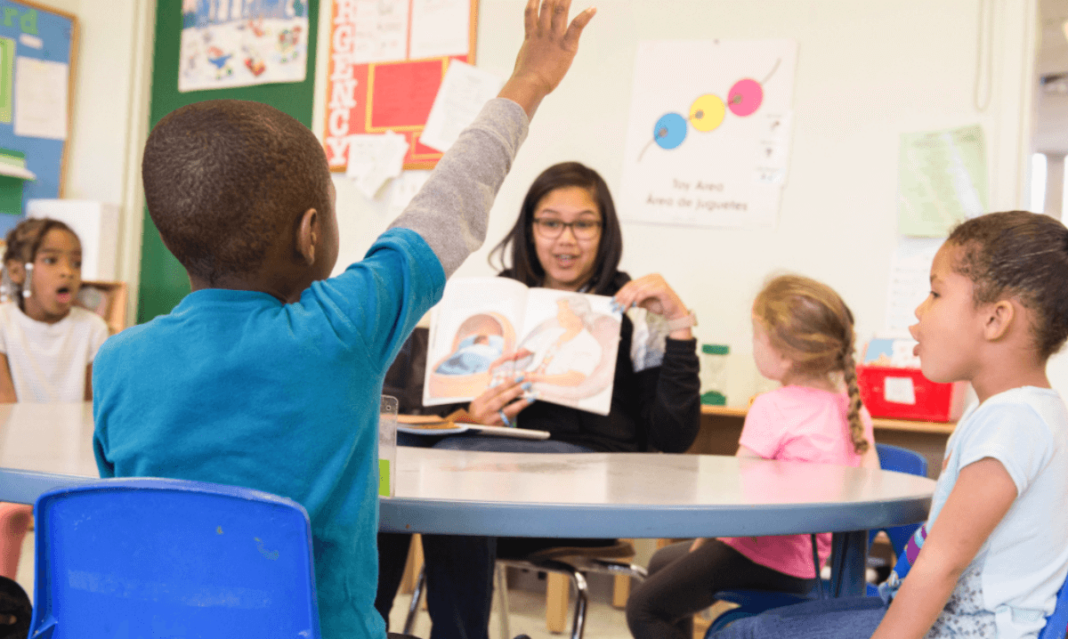 a photo of teacher teaching kids in dertroit school