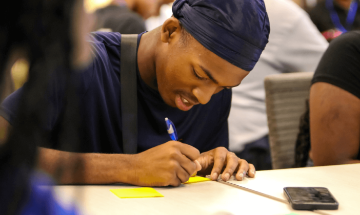 student-taking-notes-college-prep-week-gvsu