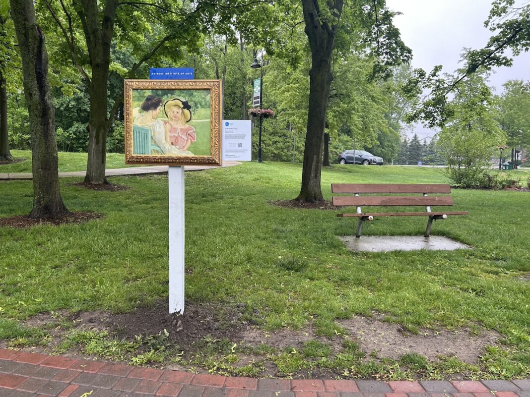 Detroit Institute of Arts Inside|Out exhibit featuring framed artwork in a Macomb County park, part of the InsideOut Macomb County public art initiative.
