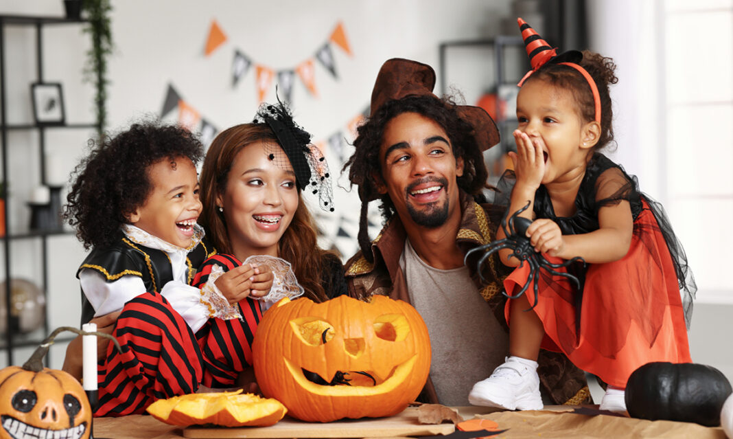 Happy family preparing Halloween decorations