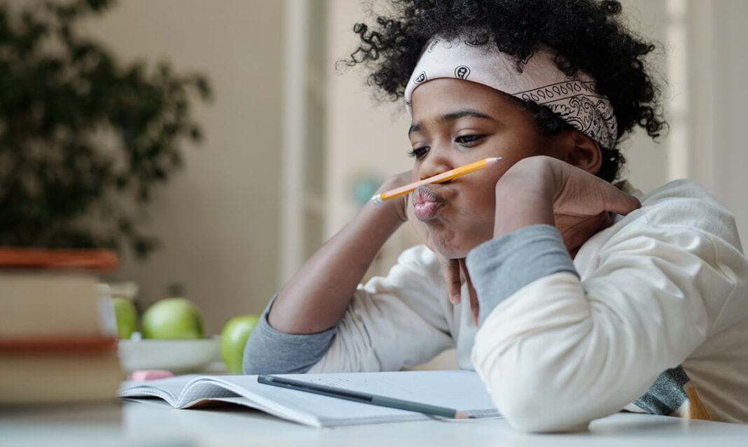 child-procratinating-playing-with-pencil