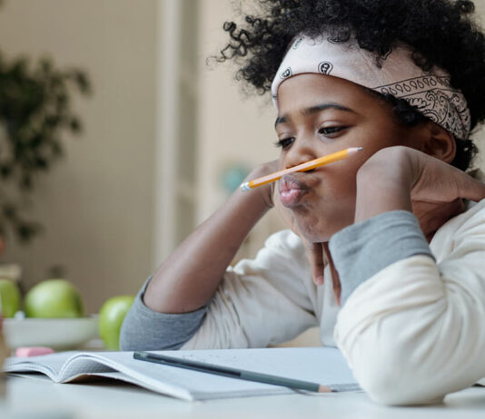 child-procratinating-playing-with-pencil
