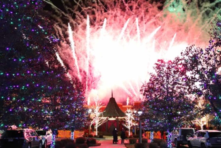 Fireworks light up the sky during Light the Village at The Village of Rochester Hills surrounded by glowing holiday lights.