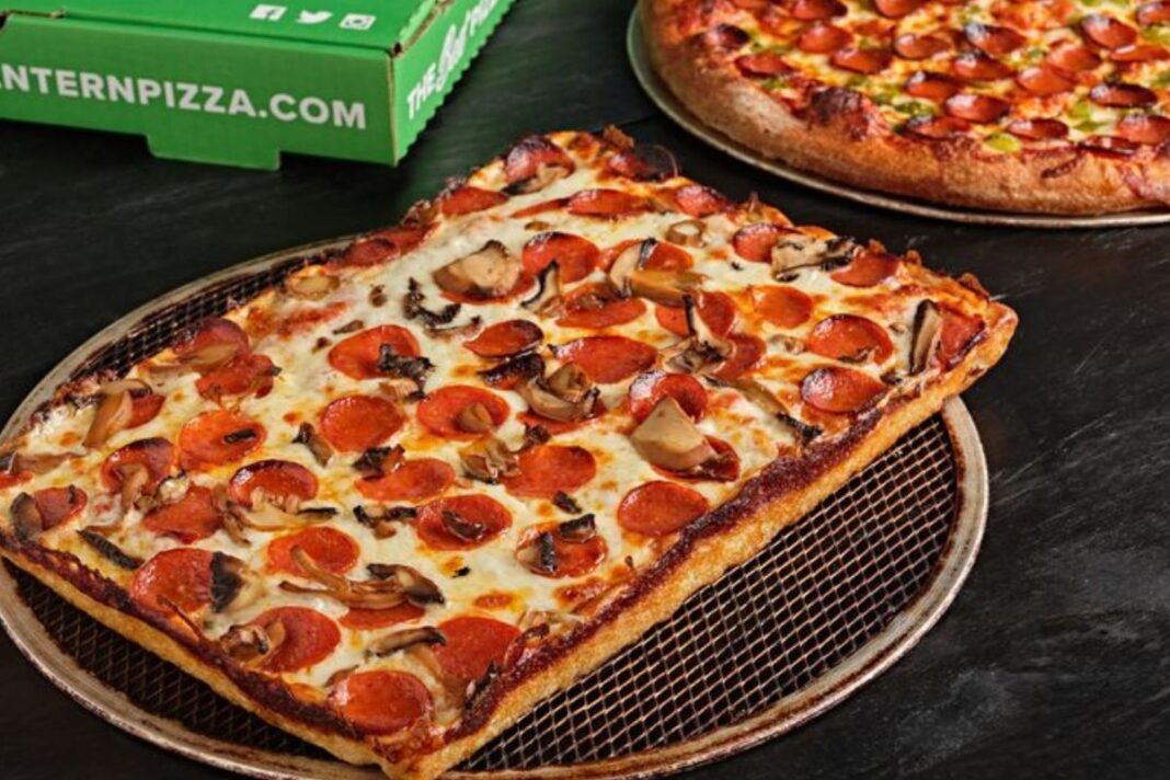 A delicious Detroit-style pizza from Green Lantern Pizza, featuring a thick crust, generous cheese and toppings, showcasing one of the iconic Detroit dishes.