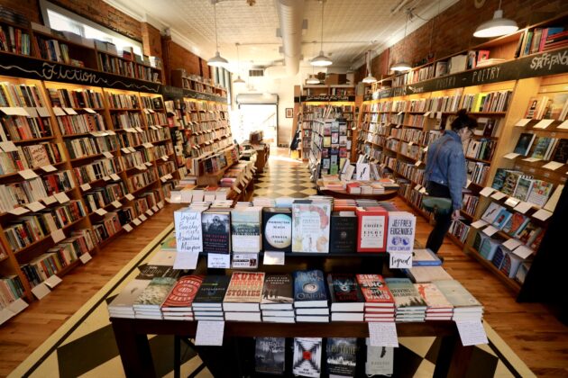 Literati independent bookstore in Ann Arbor, featuring shelves full of books and a cozy atmosphere for families to explore and shop.