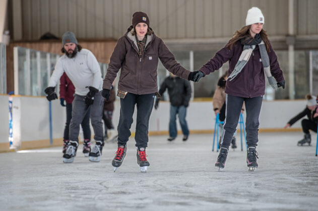 Families enjoying indoor ice skating at Buhr Park Ice Arena in Ann Arbor, a fun and family-friendly activity for all ages.