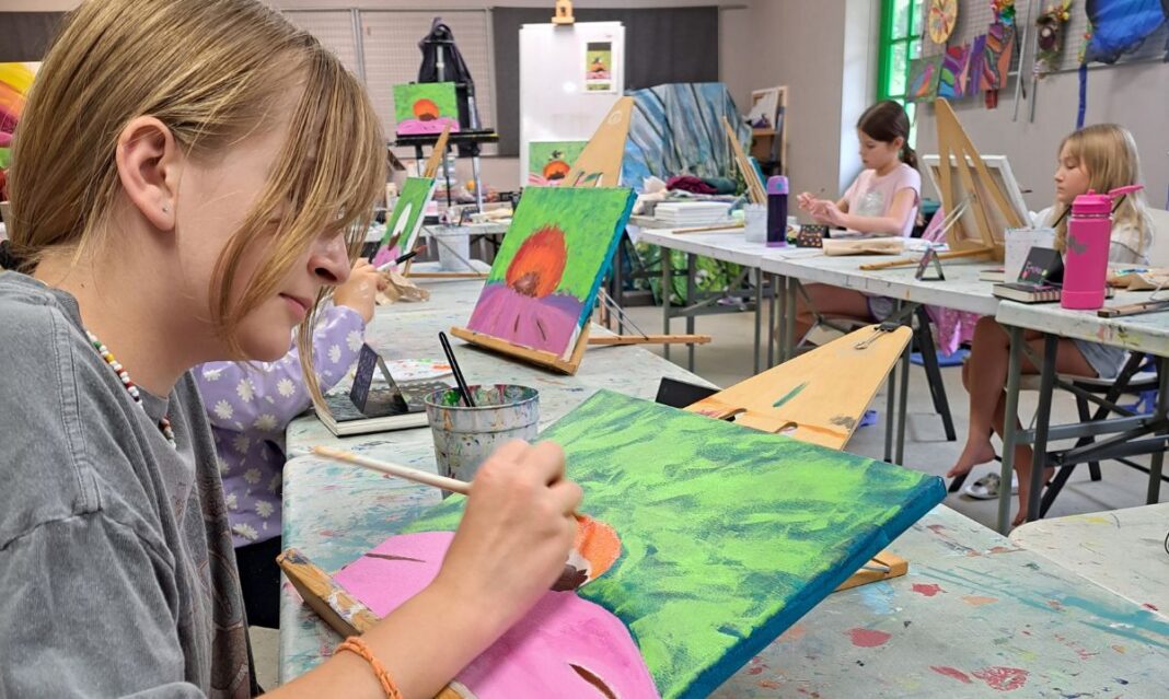 Kids painting colorful canvases at Northville Art House Summer Camp, where young artists explore creativity, learn new techniques and develop their artistic skills.