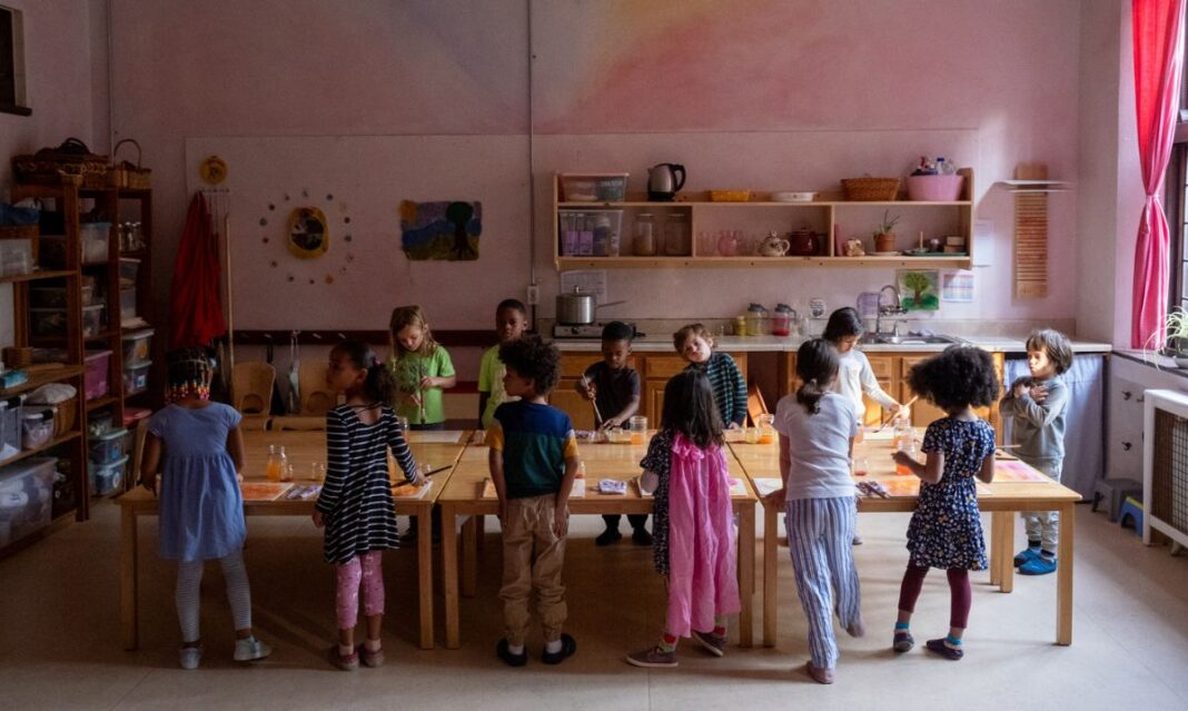 A group of young children engaged in hands-on learning activities in a warm and inviting classroom at Detroit Waldorf School, fostering creativity and collaboration.