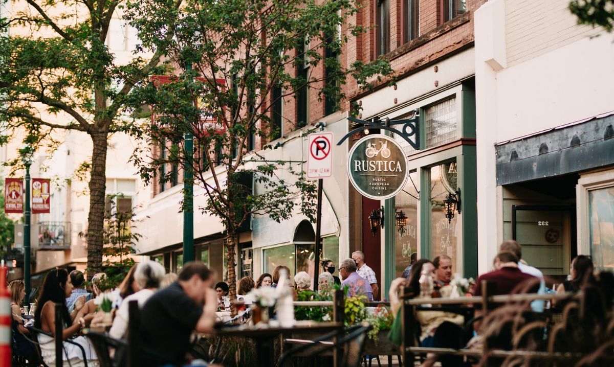 People enjoy outdoor dining at Rustica, a European-inspired restaurant on Kalamazoo Mall, a lively pedestrian shopping and dining district in downtown Kalamazoo.