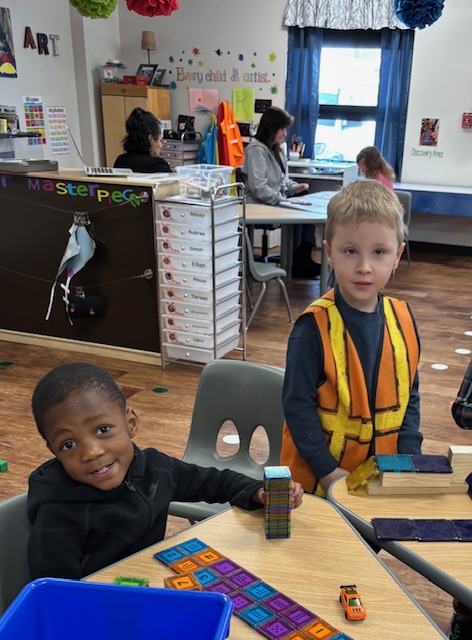 Preschool students at an elementary school in Romulus engaged in hands-on learning with building materials, fostering creativity and problem-solving skills.