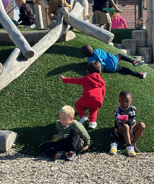 Preschool students at an elementary school in Romulus engaging in outdoor play, developing motor skills, independence, and social interaction.