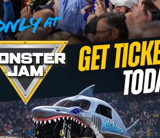 Monster Jam truck Megalodon jumps during a live show at Ford Field in Detroit with fans cheering for the family event.