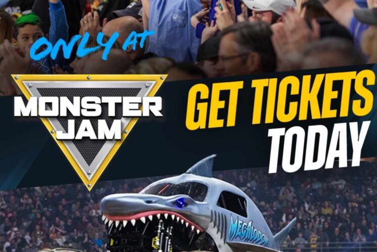 Monster Jam truck Megalodon jumps during a live show at Ford Field in Detroit with fans cheering for the family event.